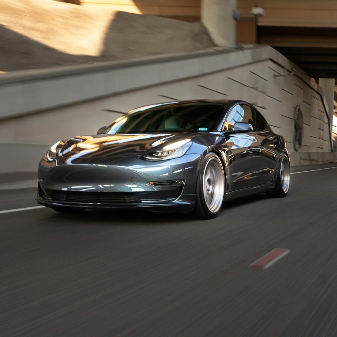 a black coupe car on the road